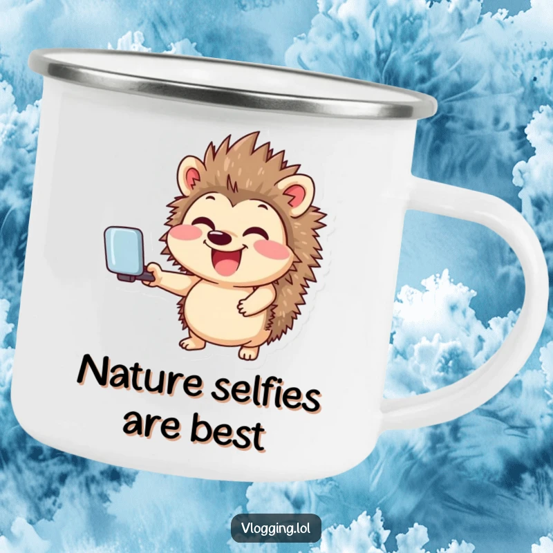 Funny enamel camping mug featuring a giggling hedgehog smiling widely while holding a selfie stick, ideal for humorous social media adventures.