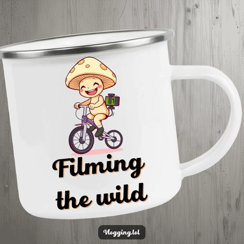 Funny mushroom unicyclist camping mug: A grinning mushroom on a unicycle holds filming equipment in a nature setting. Outstanding funny gift.