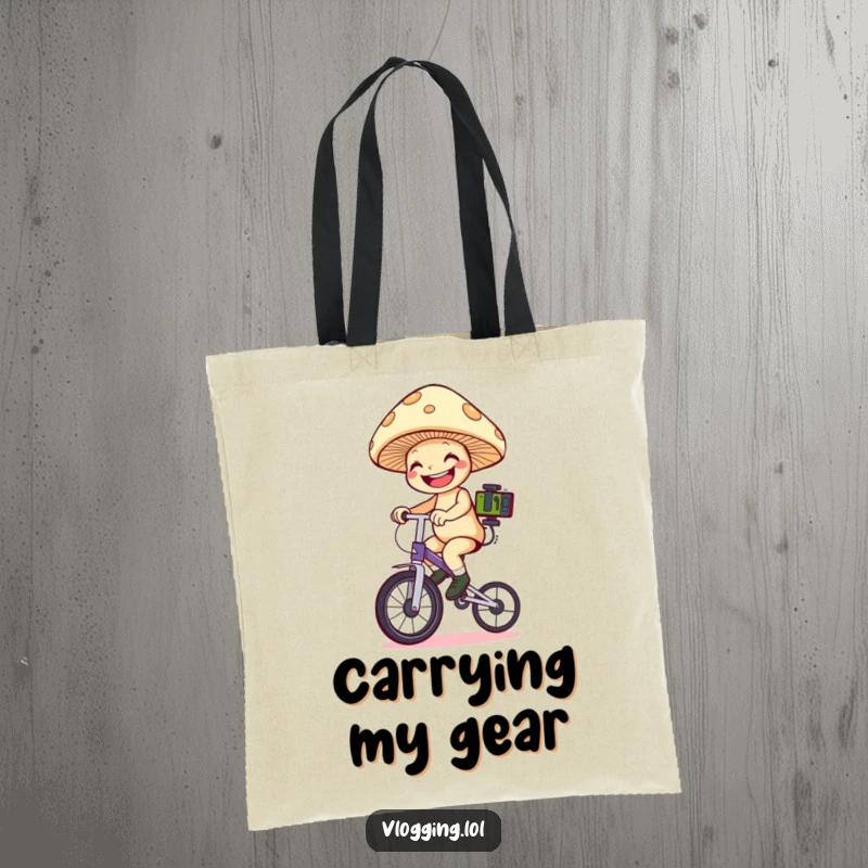 Funny mushroom unicyclist tote bag: A grinning mushroom on a unicycle holds filming equipment, ready to capture amazing footage. Perfect funny gift.
