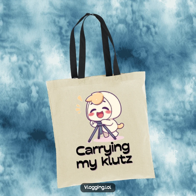 Funny tote bag showing a giggling character stumbling over a camera tripod, a playful yelp implied.